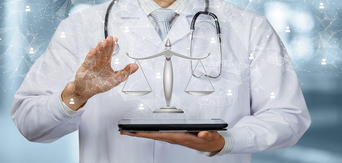 The doctor shows the scales of justice on the tablet.